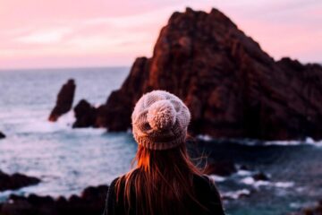 woman at sunset looking out to ocean