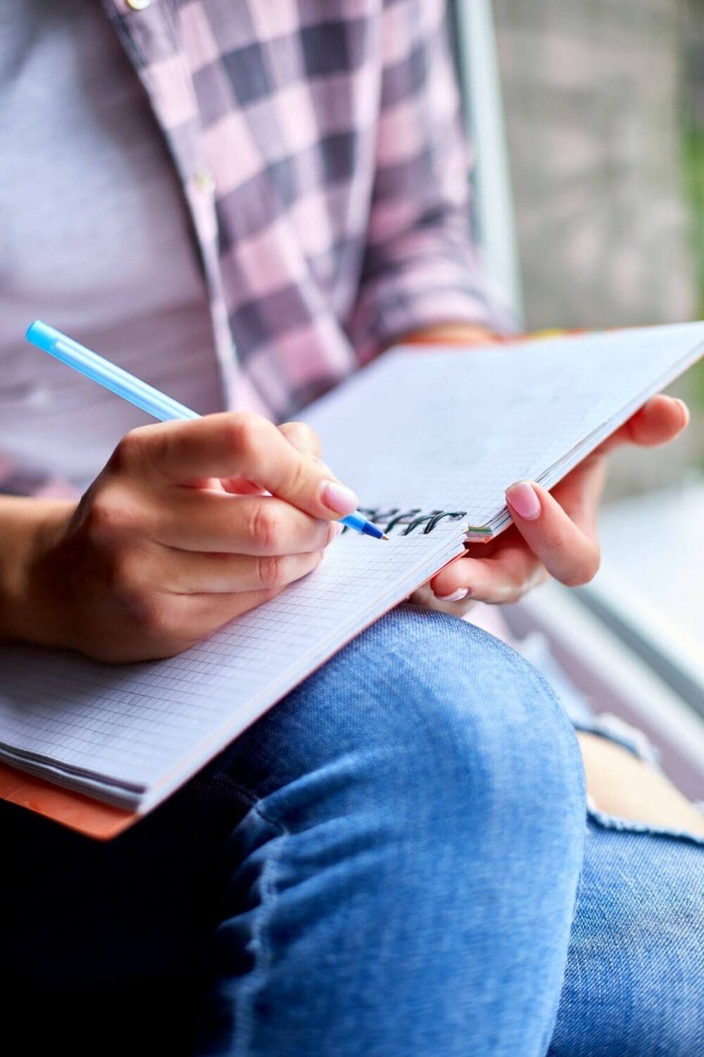 person writing in their journal