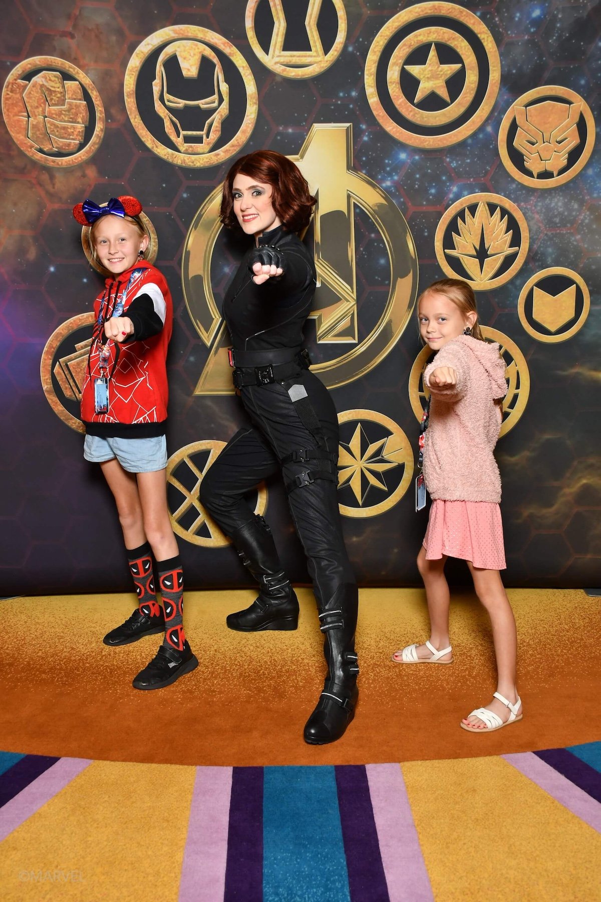 two little girls posing with black widow on the disney wonder.