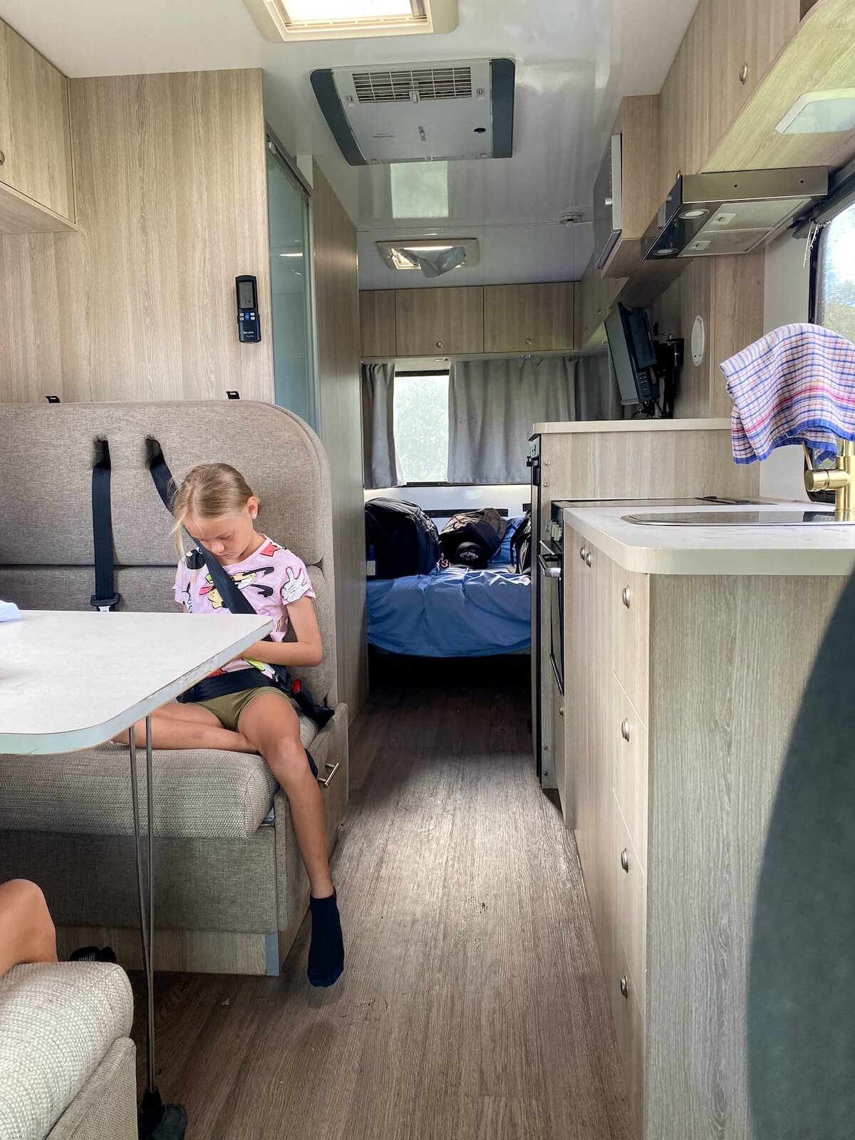 child buckled into seatbelt in polaris 6 motorhome.