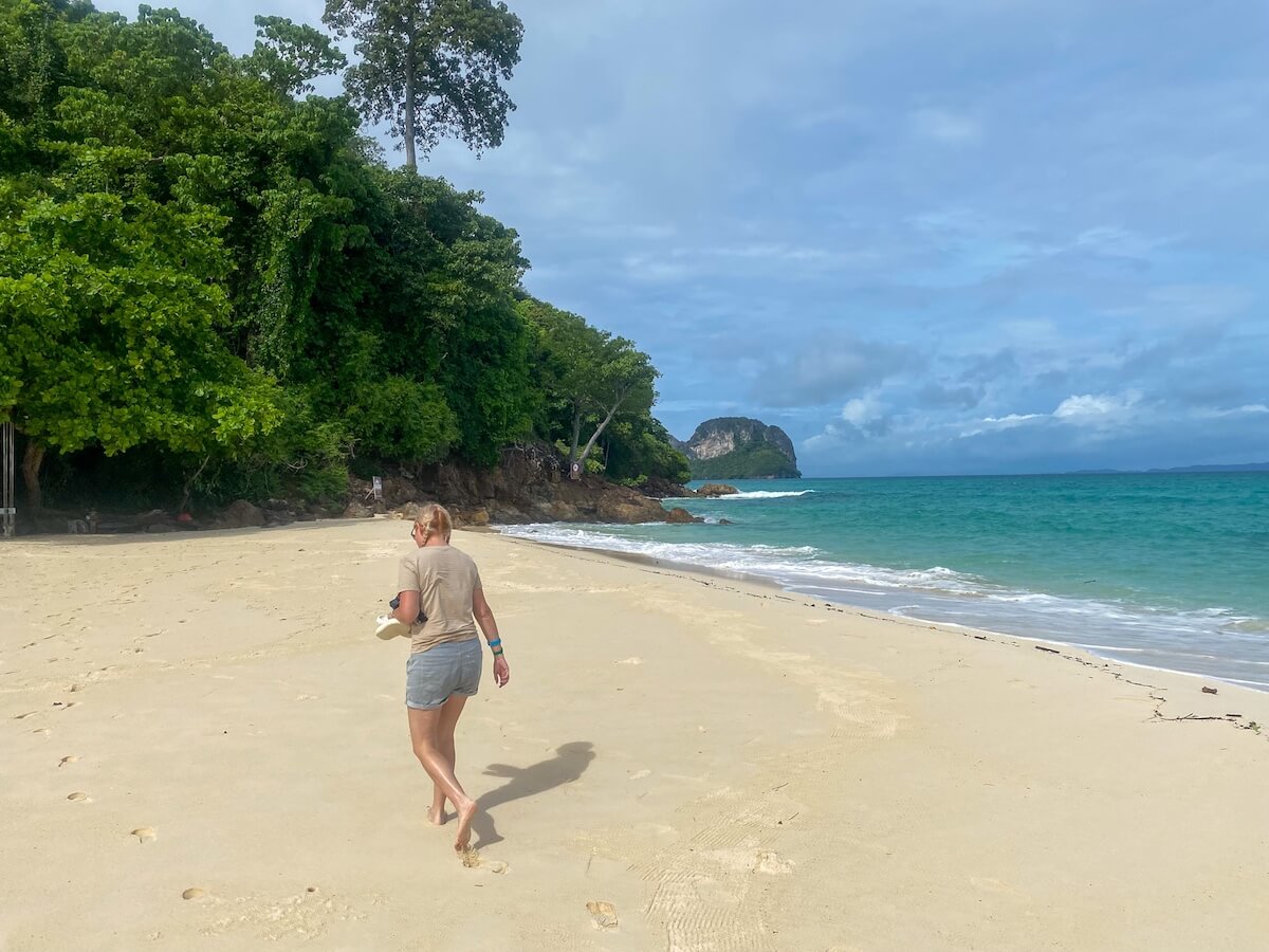 woman walking along bamboo island in phi phi islands.