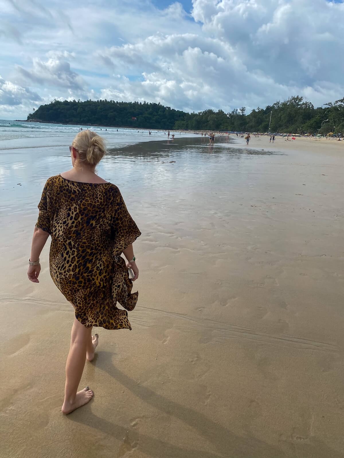 woman walking along kata beach.