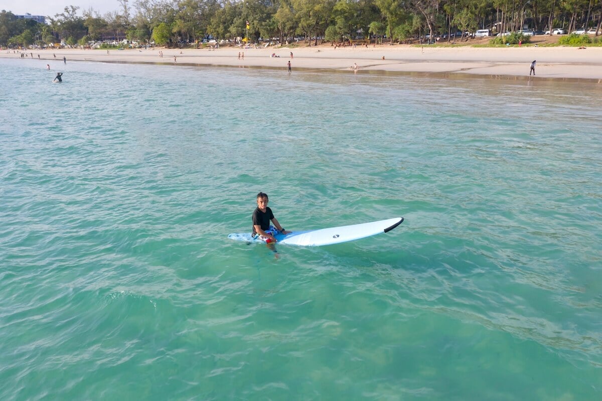 man on surfboard at kata beach.