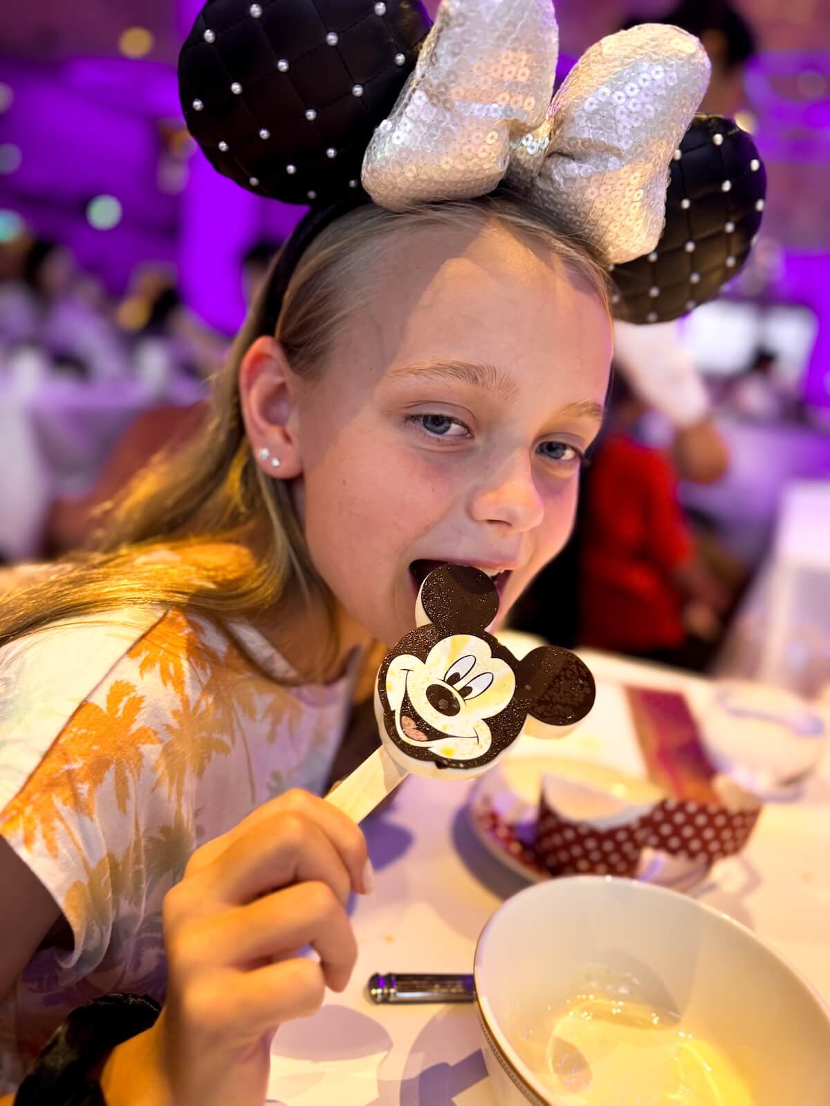 eating a mickey bar on the disney adventure cruise.