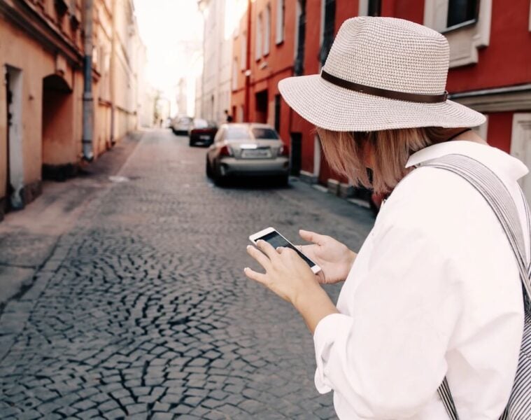 woman using phone to navigate while travelling.
