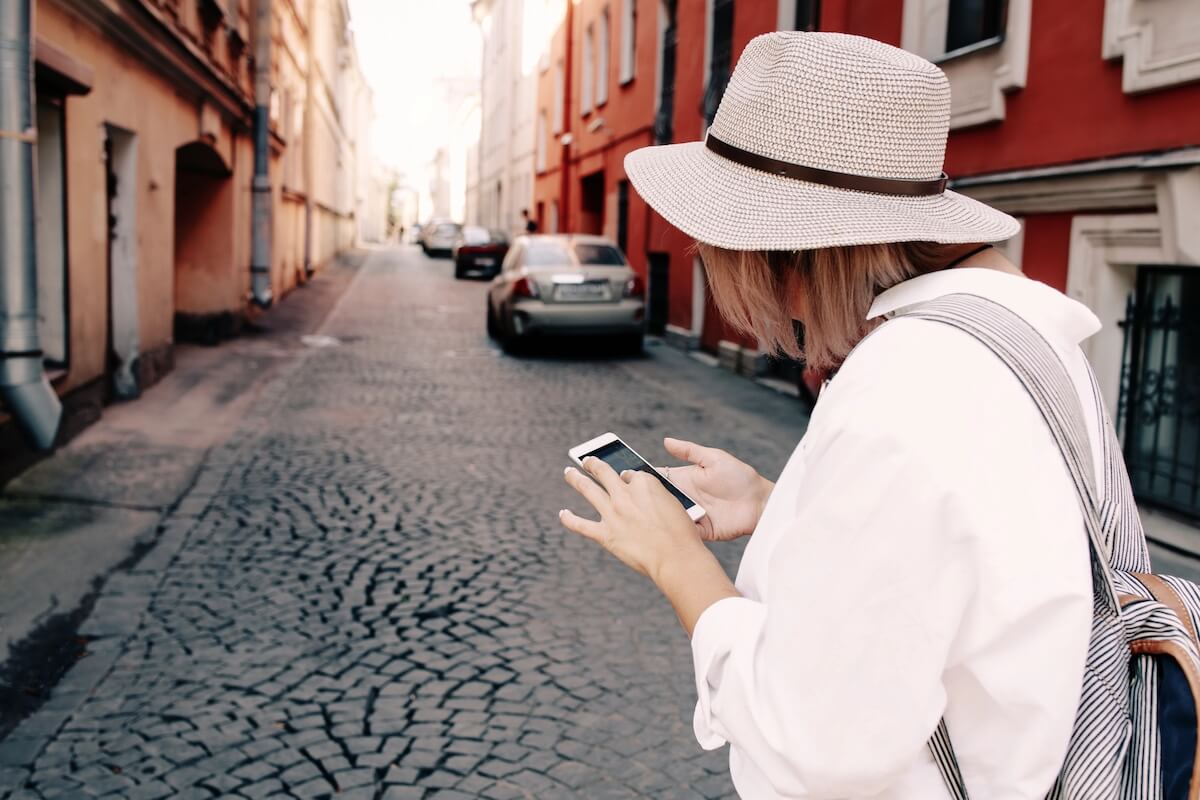 woman using phone to navigate while travelling.